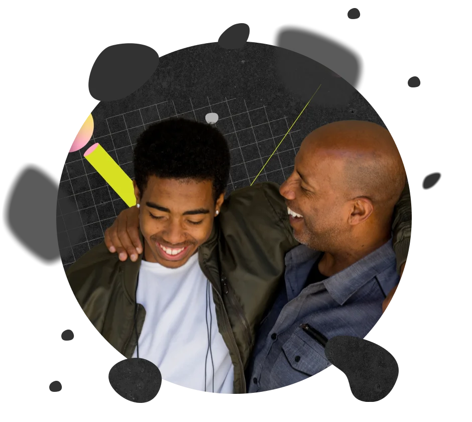 Father and son hugging and smiling.